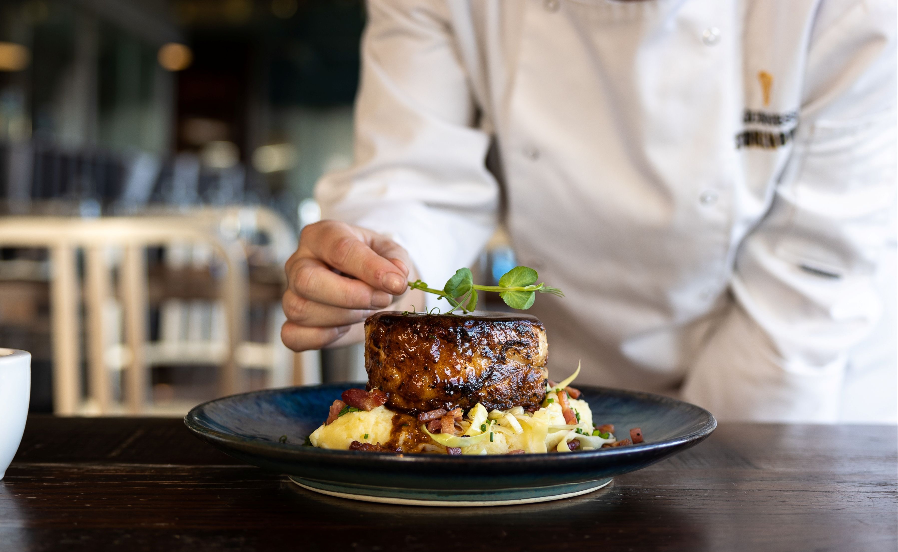An image of a food being decorated by Chef