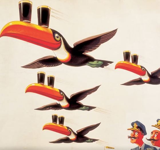 A vintage Guinness ad featuring an illustrated toucan flying and balancing two pints of Guinness on it's beak.