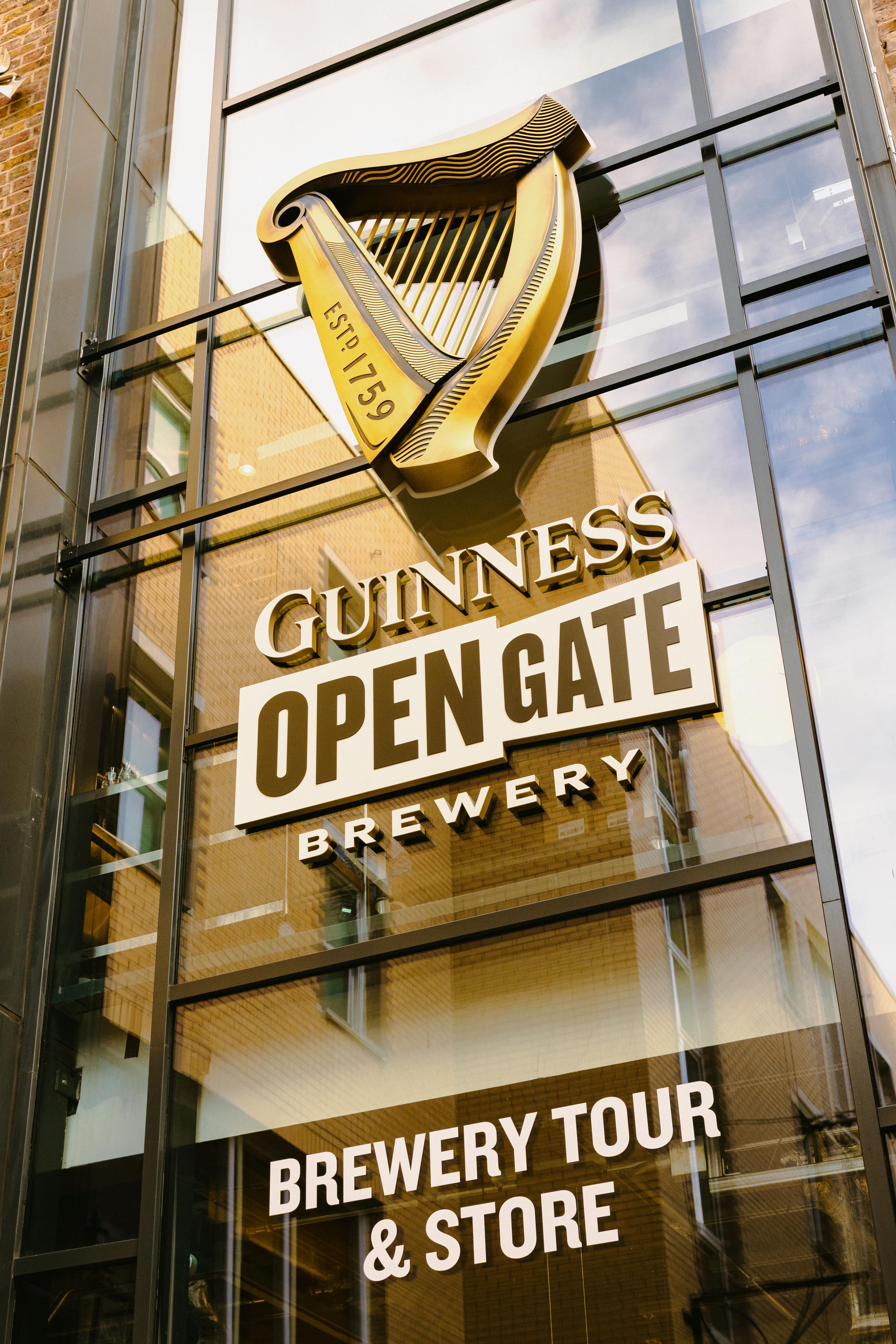 Exterior image of building with large glass panel and Guinness Opengate Brewery signage