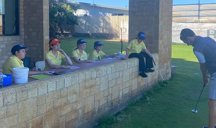 Albany's Australian Golf Foundation Junior Girls Golf Scholarship program recipients watching on during a putting lesson.