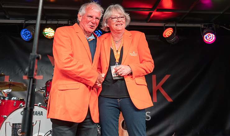 Roma Golf Club's Barbara Slater receives her orange jacket at Longreach last year.