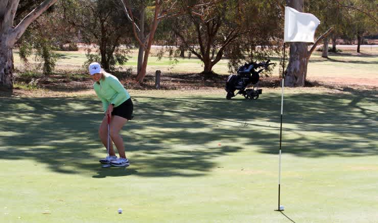 Eliza Baker of the Glenelg golf club sinks a great putt on the 9th Green during the opening round of the Championship event of the 2021 Port Augusta Golf Classic. Eliza went on to secure the A Grade Ladies Championship.
