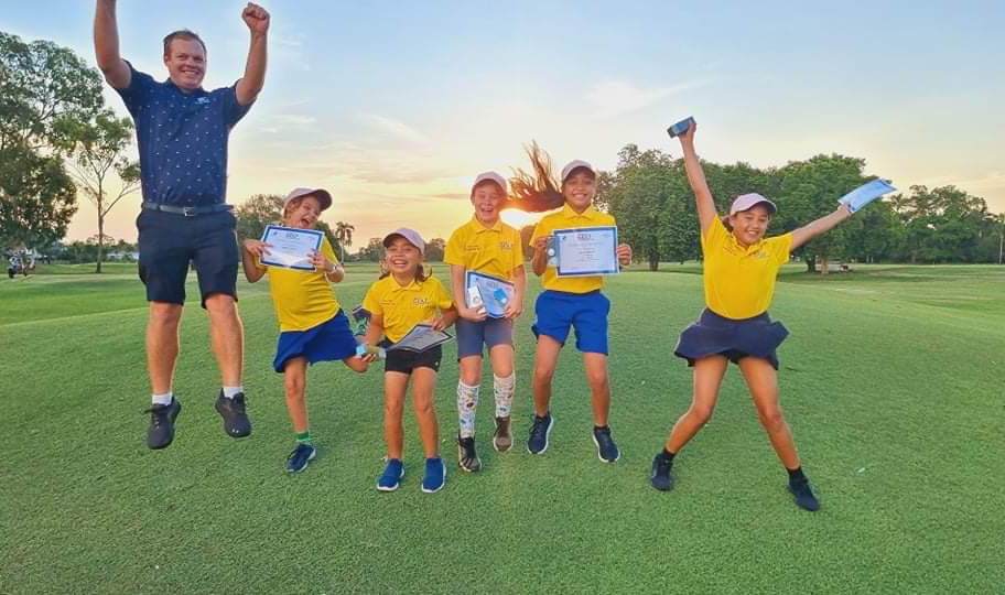 Jumping for joy!  Darwin girls and Robert Dehne celebrate their graduation with certificates and Callaway packs gifted from Callaway.