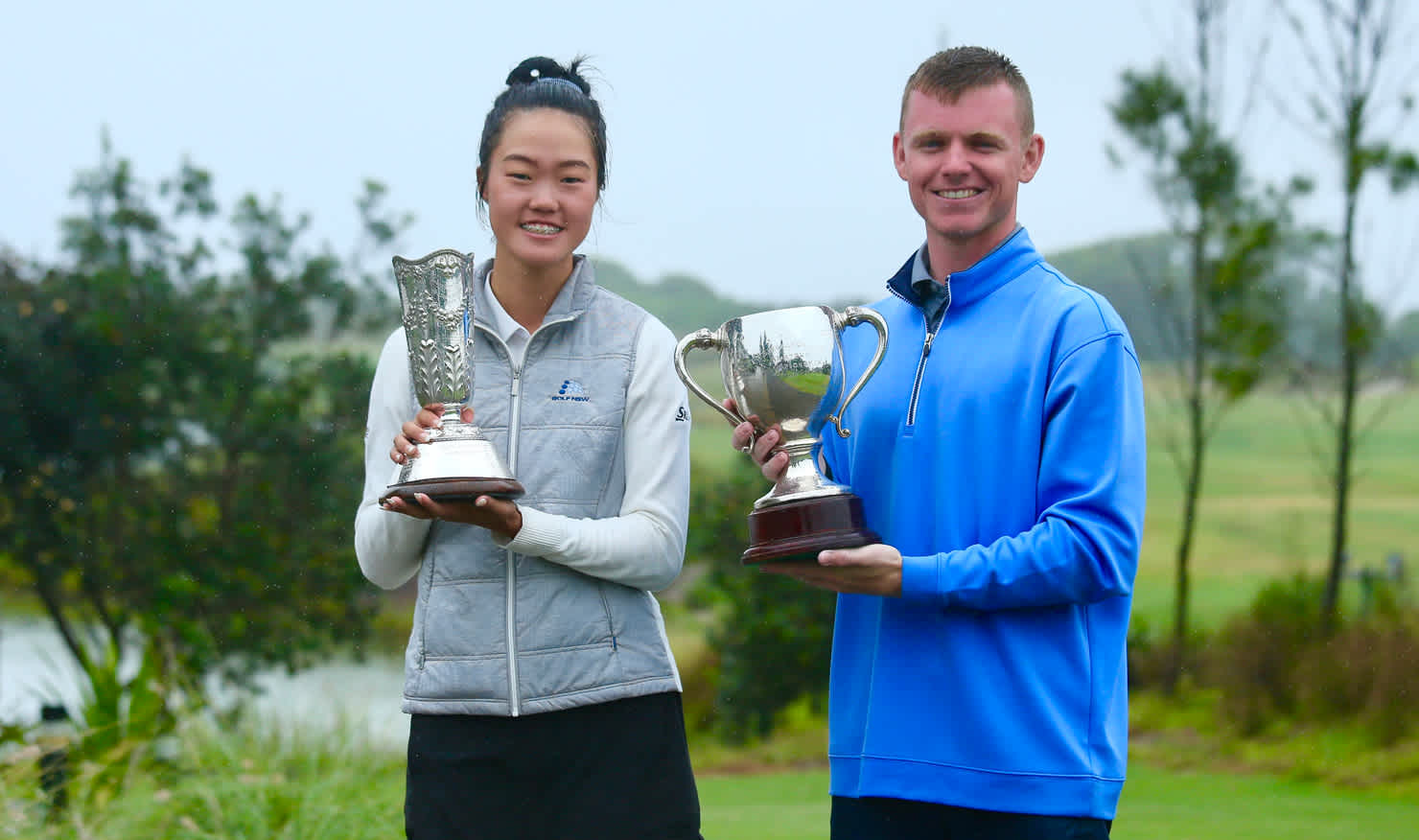 Grace Kim and Andrew Richards show off the spoils of victory at Magenta Shores. Picture: DAVID TEASE