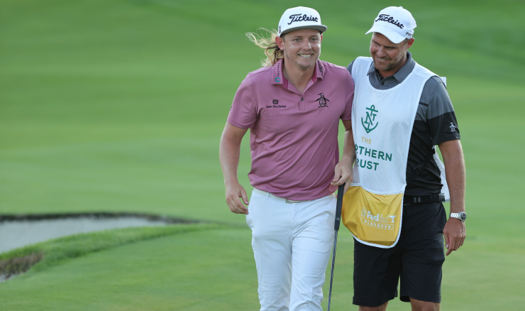 Cam Smith smiling with his caddy at the Northern Trust.