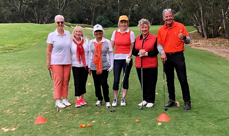 More than golf. Get Into Golf women with Tony wearing orange to support their fellow beginner golfer through her cancer treatment. 
