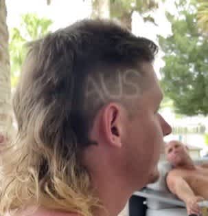 Cam Smith has 'AUS' on the side of his head for the Olympics.