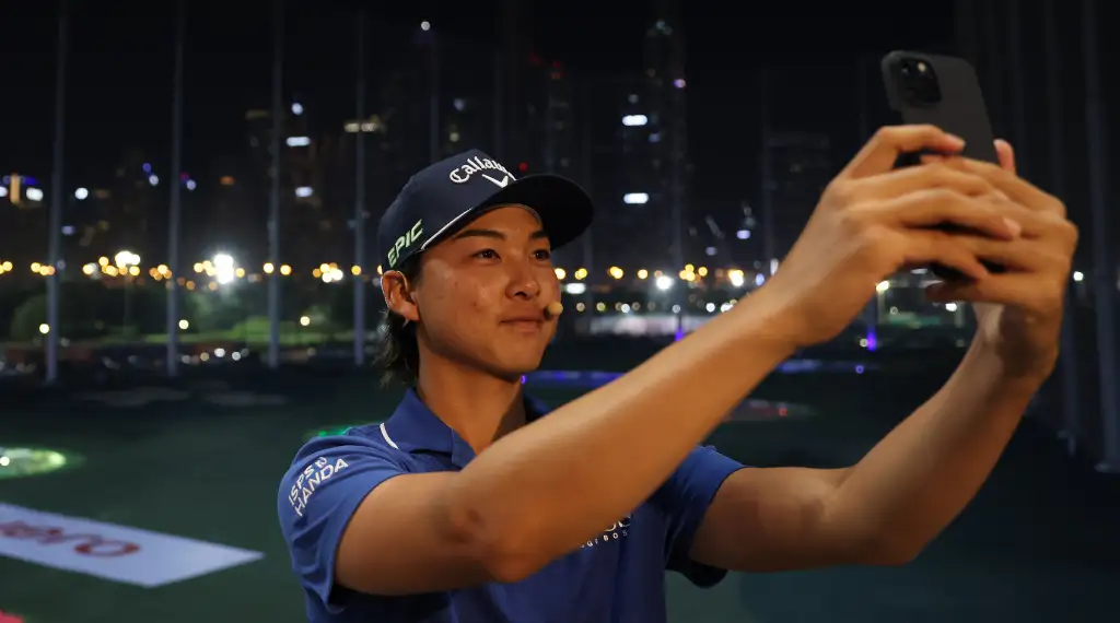 Min Woo Lee taking selfie at Top Golf in Dubai.