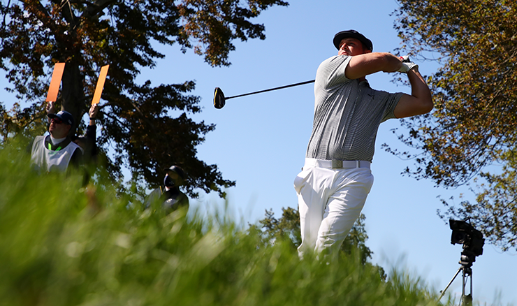 Bryson DeChambeau wields the driver seemingly immune to the potential dramas of the rough at Winged Foot. 