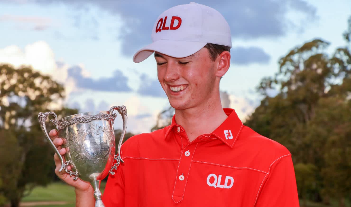 Elvis Smylie admires the 2019 Australian Boys' Amateur trophy after his win at Southport Golf Club.