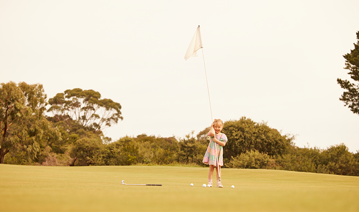 Girl with a golf flag.