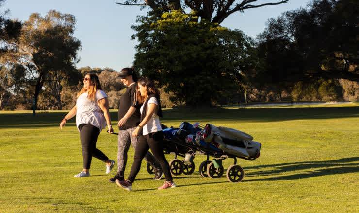 Generic women walking on a golf course.