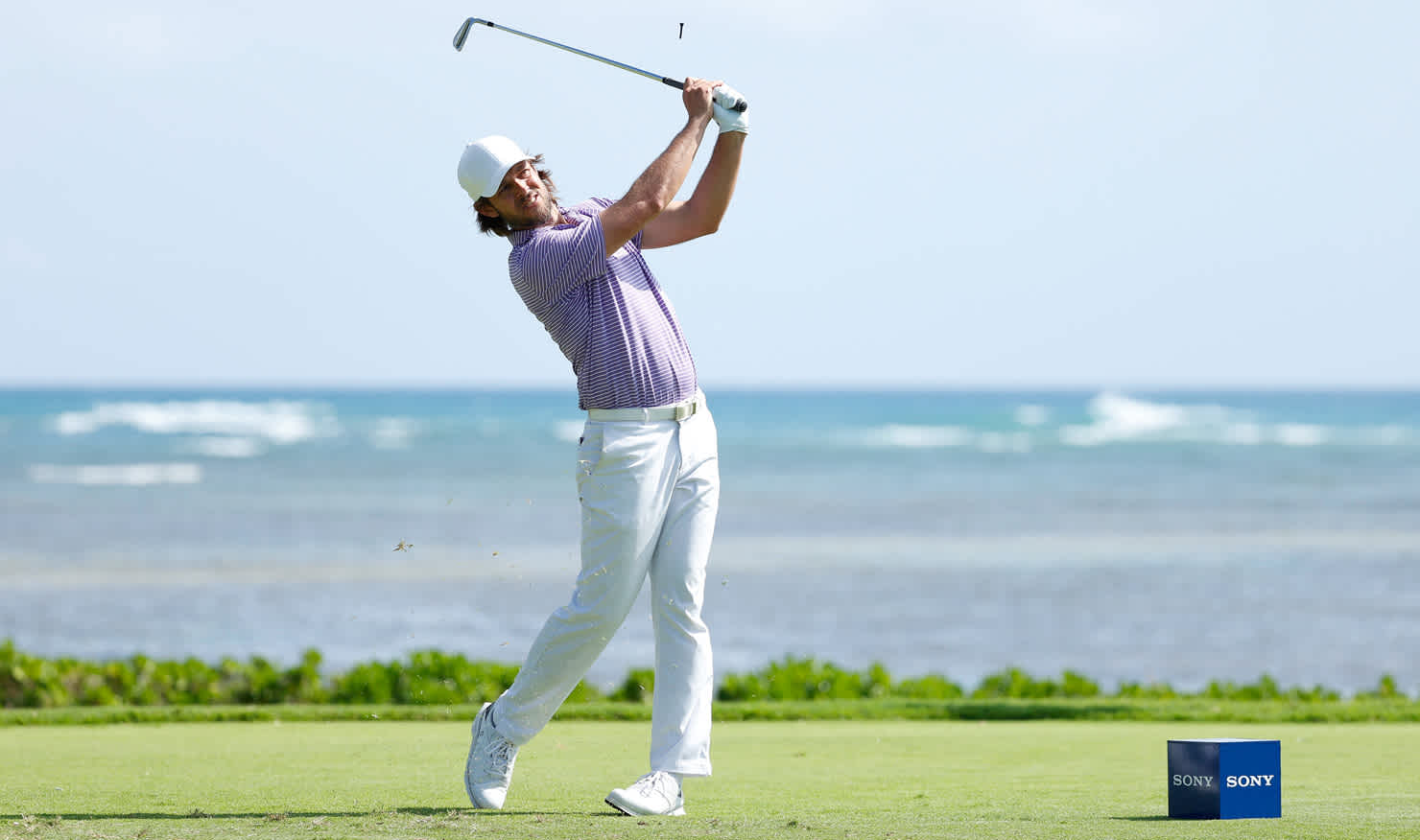 Aaron Baddeley launches his tee shot on the way to birdie on the 17th in Honolulu today.