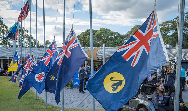 The state flags fly during the opening ceremony for the Australian Junior Interstate Teams Matches.
