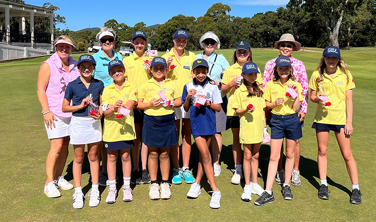 Mentors give scholarship girls love heart chocolates to ‘fall in love with golf’ on Valentine’s Day. 