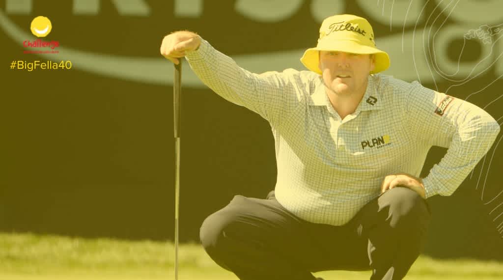 Jarrod Lyle reading a green while wearing his famous yellow hat.