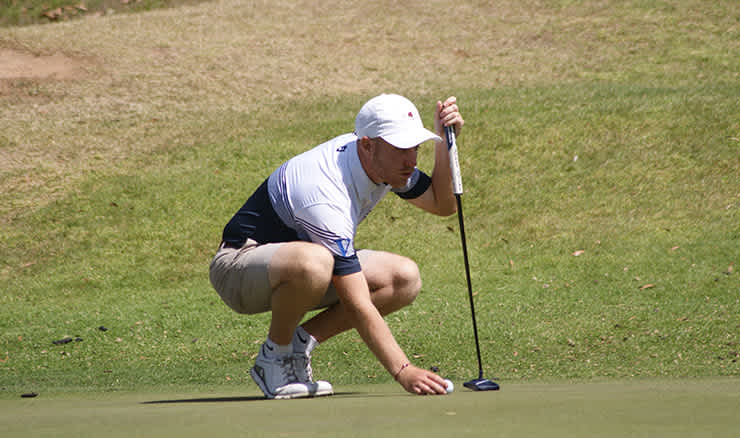 Aiden Didone lines up a putt at Ulverstone Golf Club.