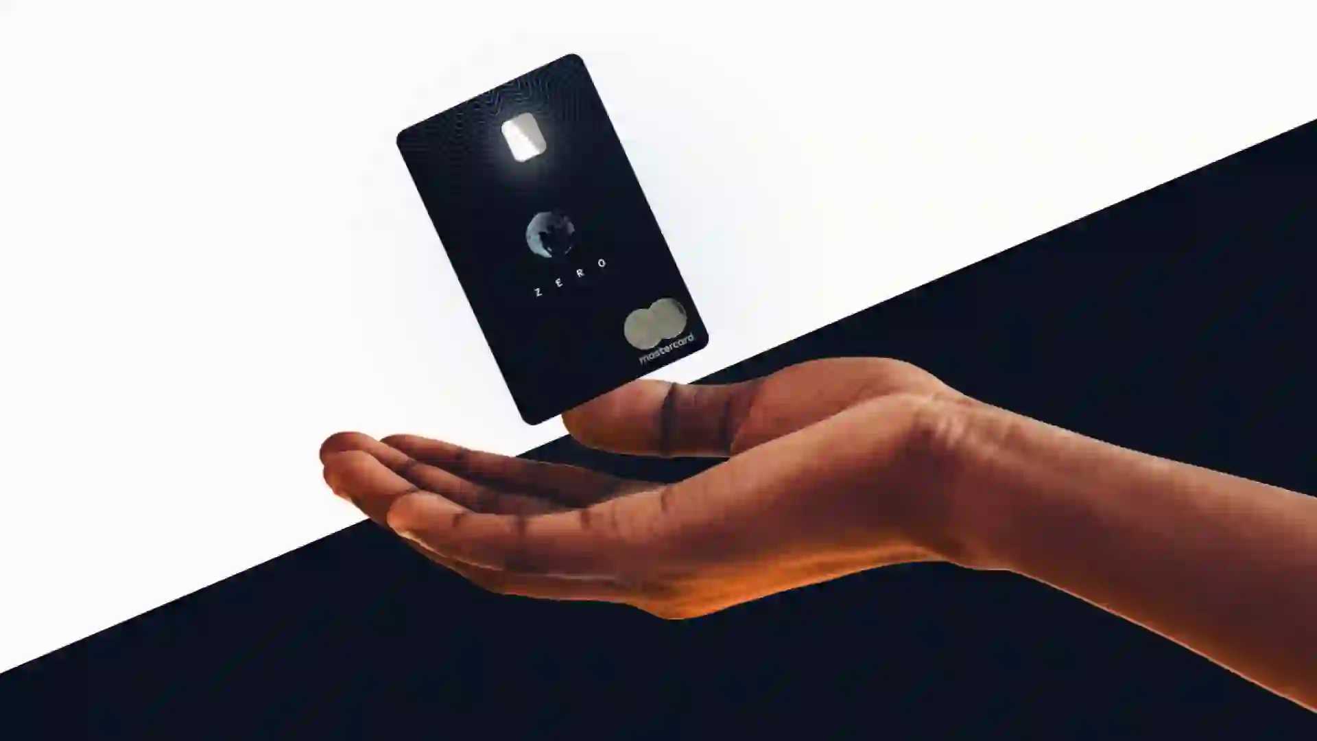 a hand holds an aspiration credit card