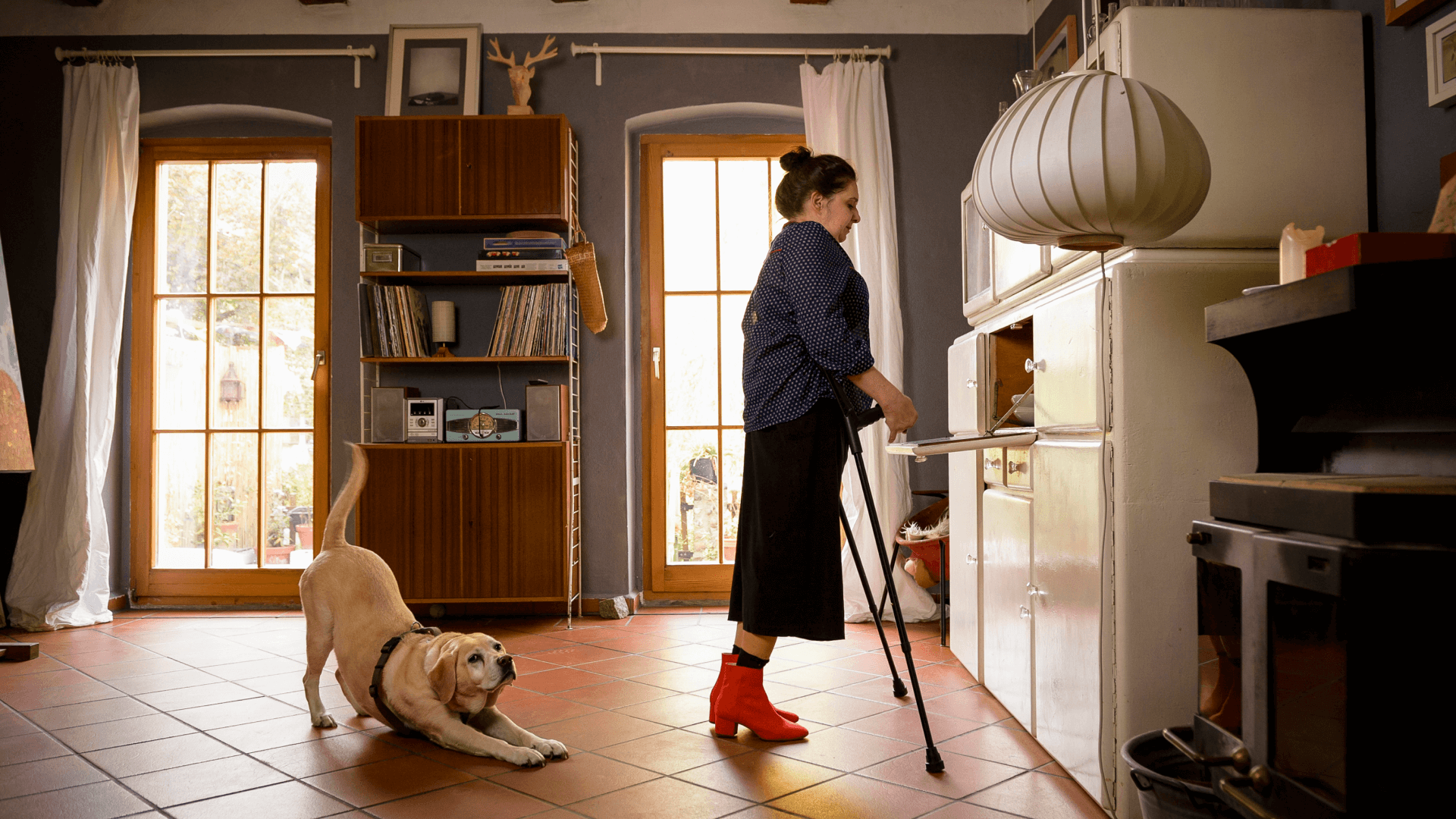 Woman with crutches, with her dog