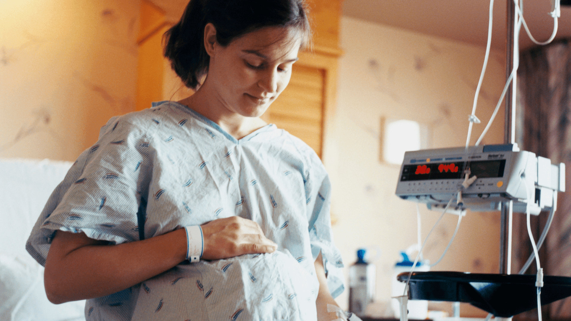 pregnant person holds stomach