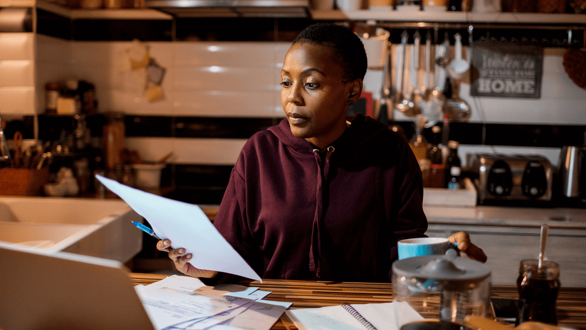 a black woman reads a piece of paper to increase her financial knowledge