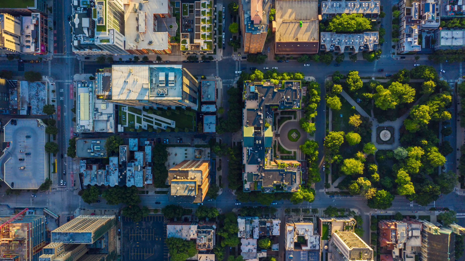 aerial view of several city blocks including big and small buildings and a park
