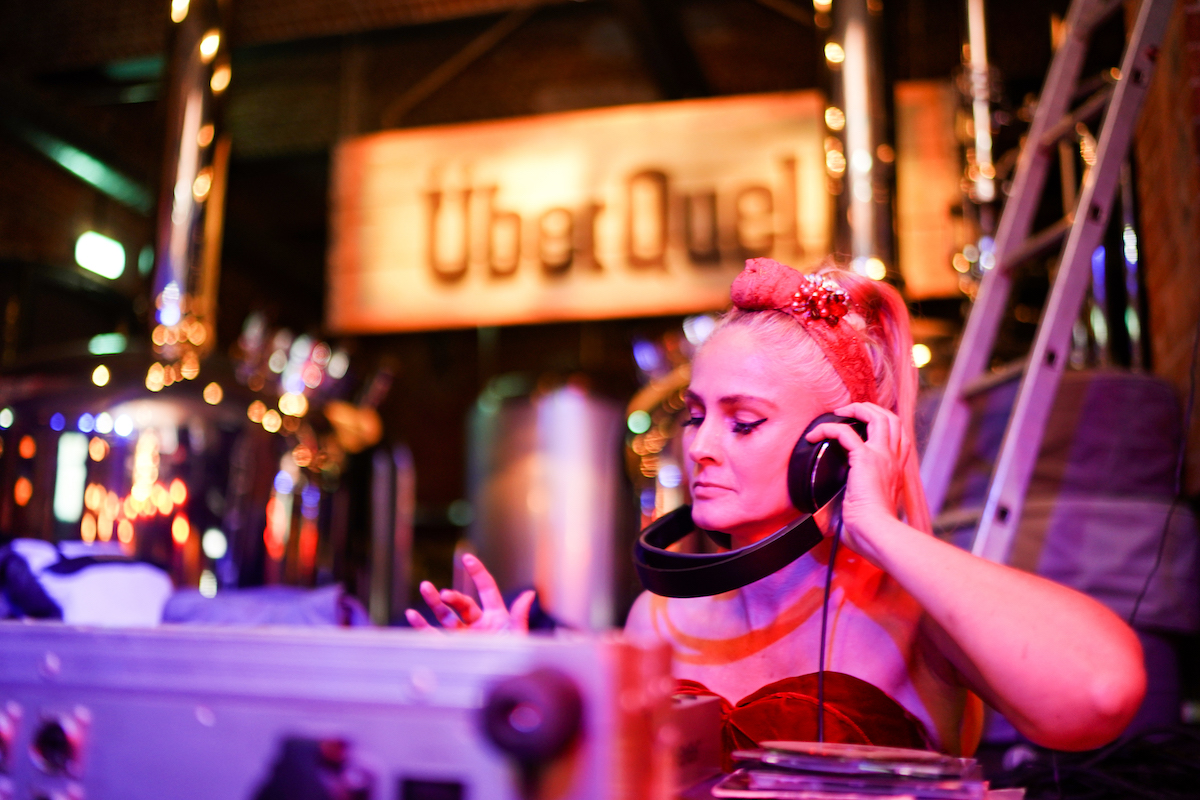 Caucasian female DJ with her eyes closed.