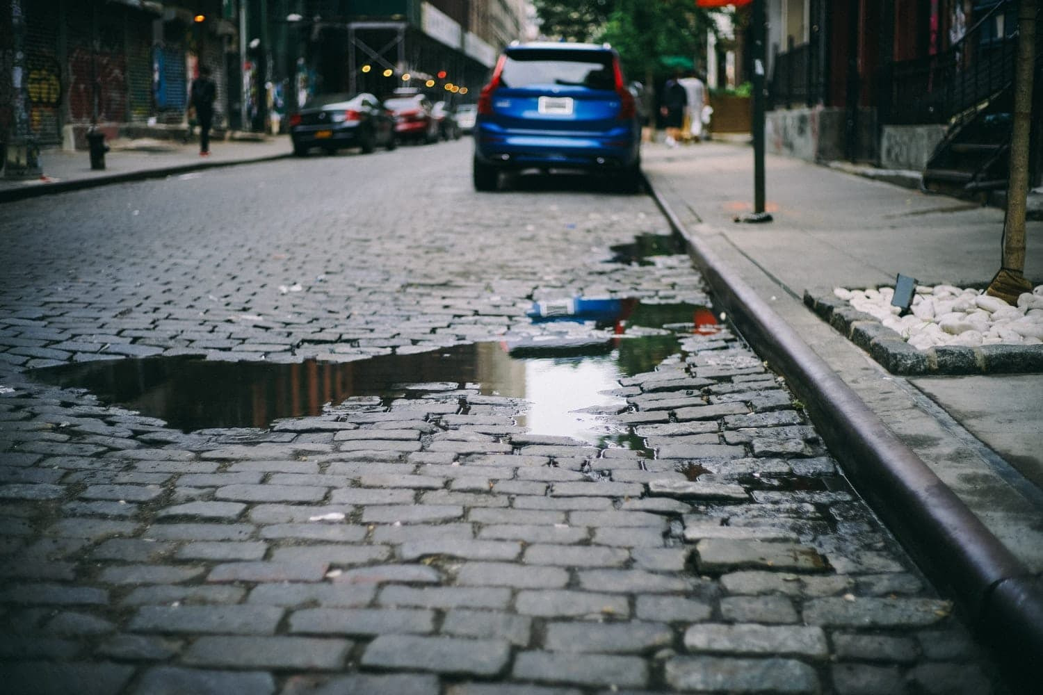 A pothole on a cobblestone road.
