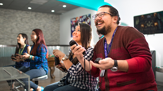 Man and woman playing video games laughing
