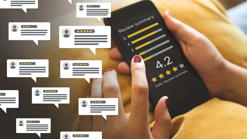 Person holding phone that displays an online review interface; floating images of reviews