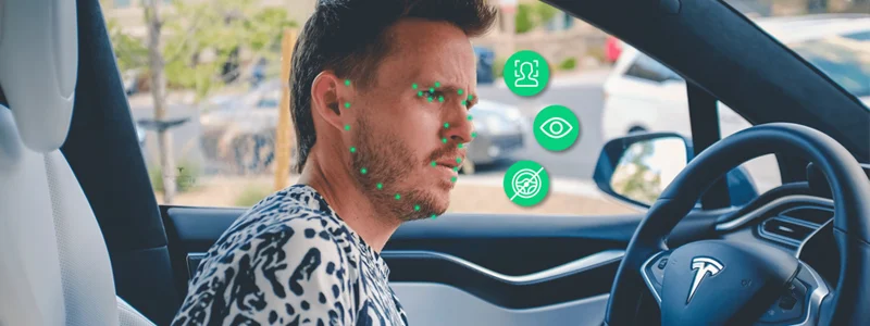 Person driving car with annotations meant to convey facial expression detection