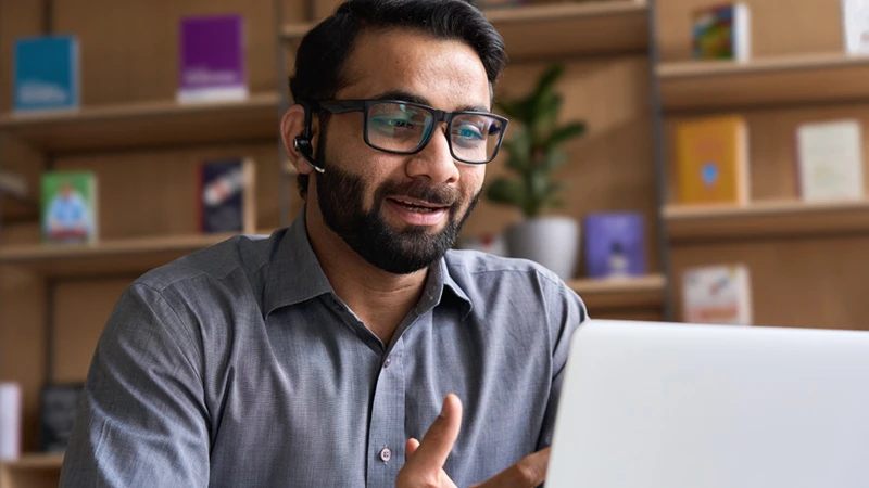 Salesperson speaking into a computer