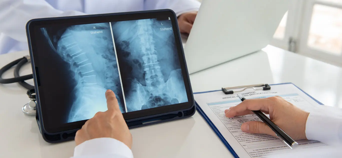 Hands of doctor pointing to an x-ray on a tablet