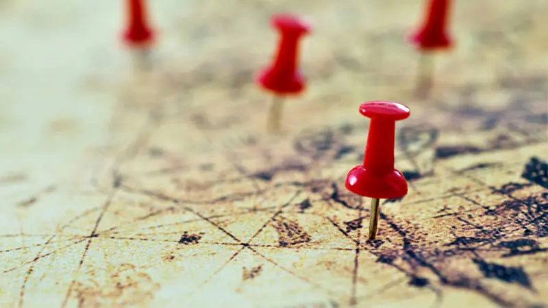 Push pins on a historical map - employee journey mapping concept