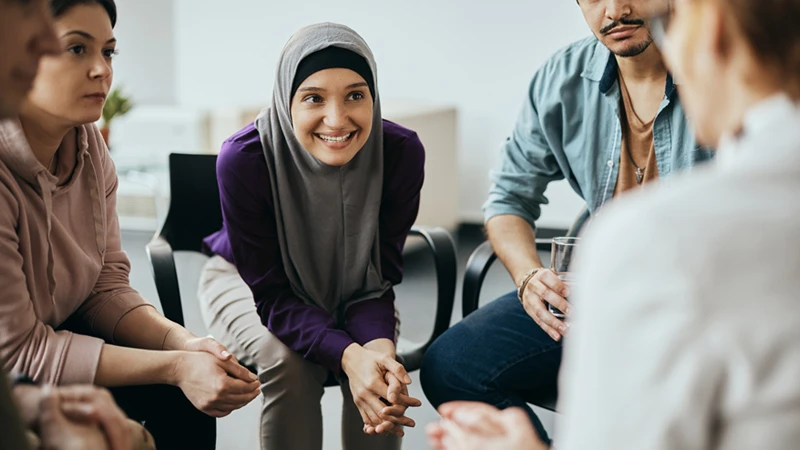 Photo of a group of people sitting in a circle, meant to represent a focus group to design for customer empathy