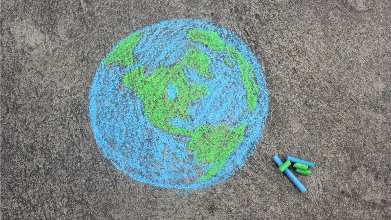 image of world drawn on pavement with chalk 