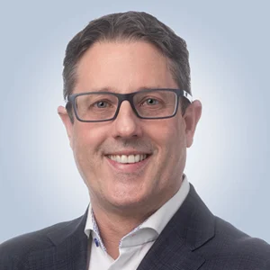 Headshot of Jason Macdonnell, Acting CEO and COO of TELUS Digital, and President, TELUS Digital Customer Experience