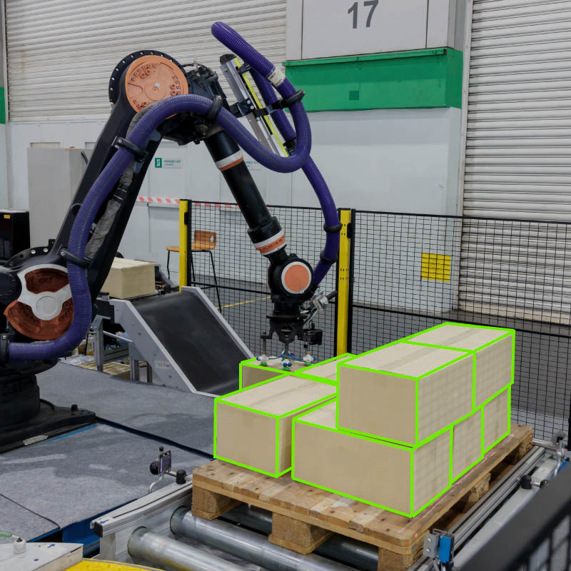 A robotic arm moving boxes, which have been highlighted in an AI annotation software