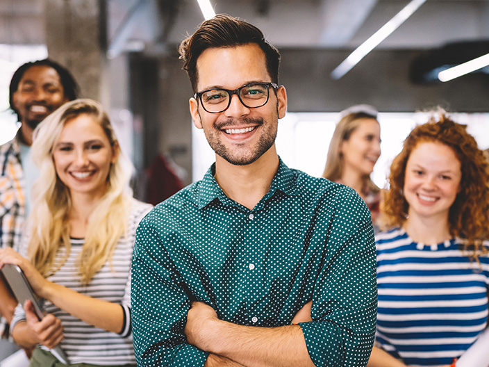 A group of professionals smiling in an office.