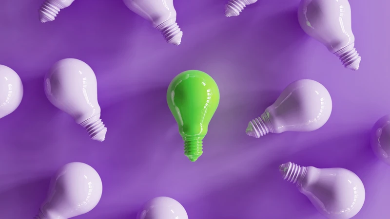 Image of a number of lightbulbs, with the center lightbulb standing out in a different color to symbolize innovative ideas