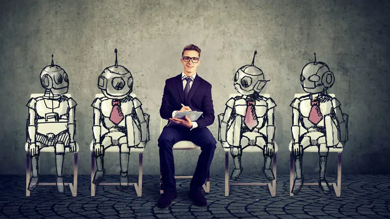 human employee sitting between bots 
