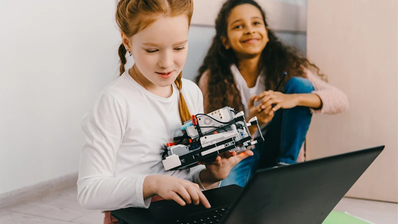 Two children experimenting with technology