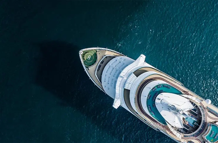 An aerial shot of a cruise ship on the water.