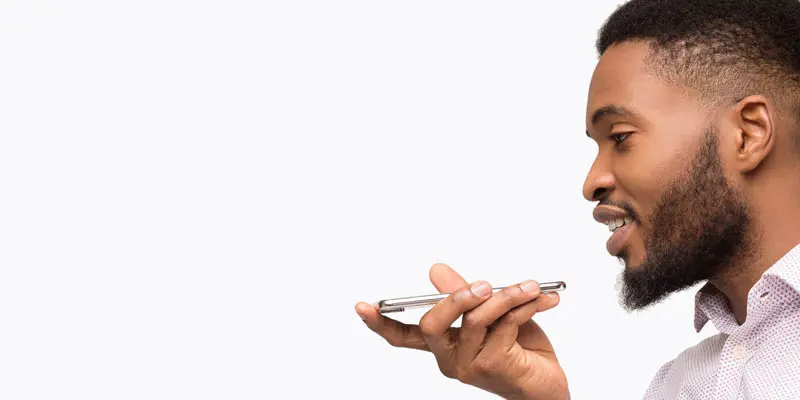 Man talking into smartphone to show natural language understanding. 