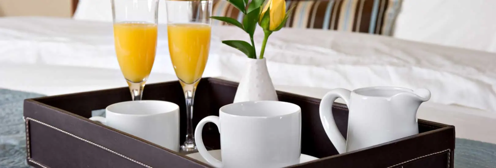 Drinks tray with coffee, orange juice and a flower center piece