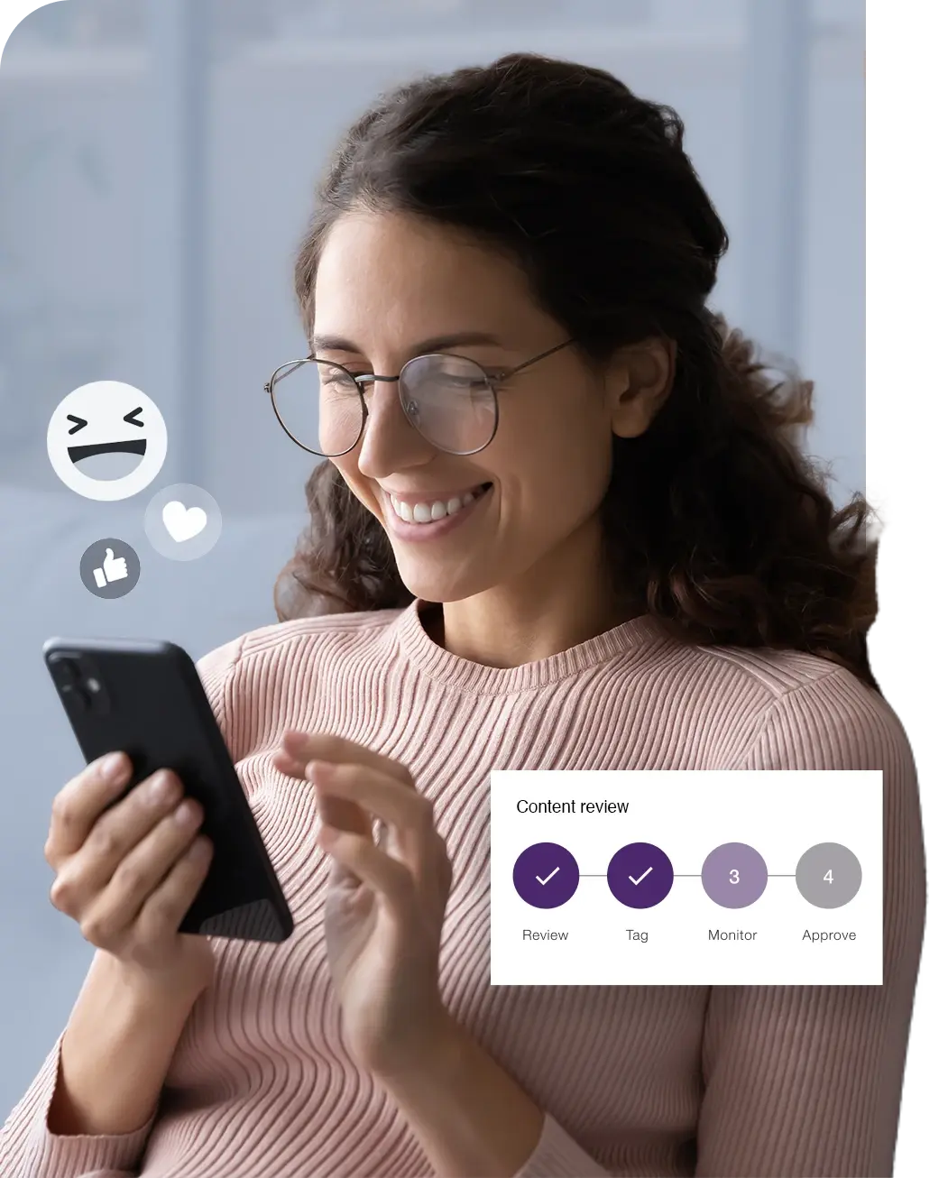 a woman in glasses smiling at a social media post with an overlay of emojis