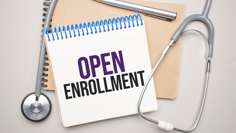 Coiled notepad with text that reads "Open Enrollment" accompanied by various medical devices