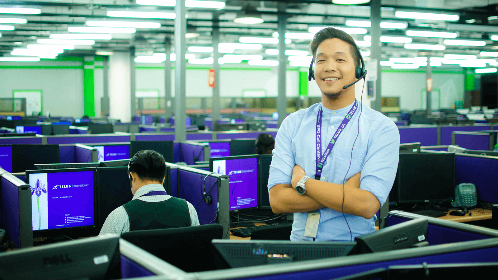 Call centre employee standing by his desk