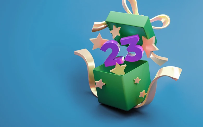 The number 23 springing out of a gift box surrounded by stars