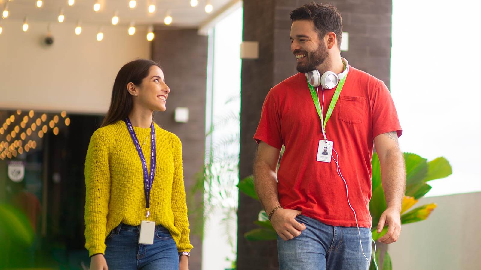 Two people walking in an office looking at each other